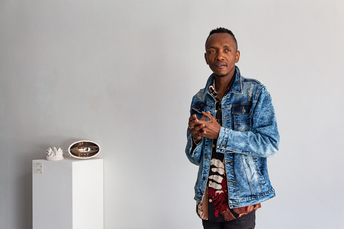 Sylvester Zanoxolo Mqeku speaks at the opening of his Solo exhibition